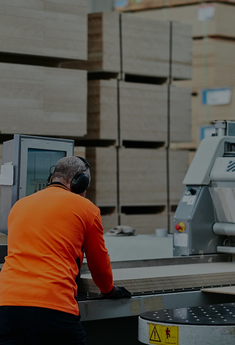 Mobile header image of a beam saw operator cutting plywood to size in Plyco Mornington