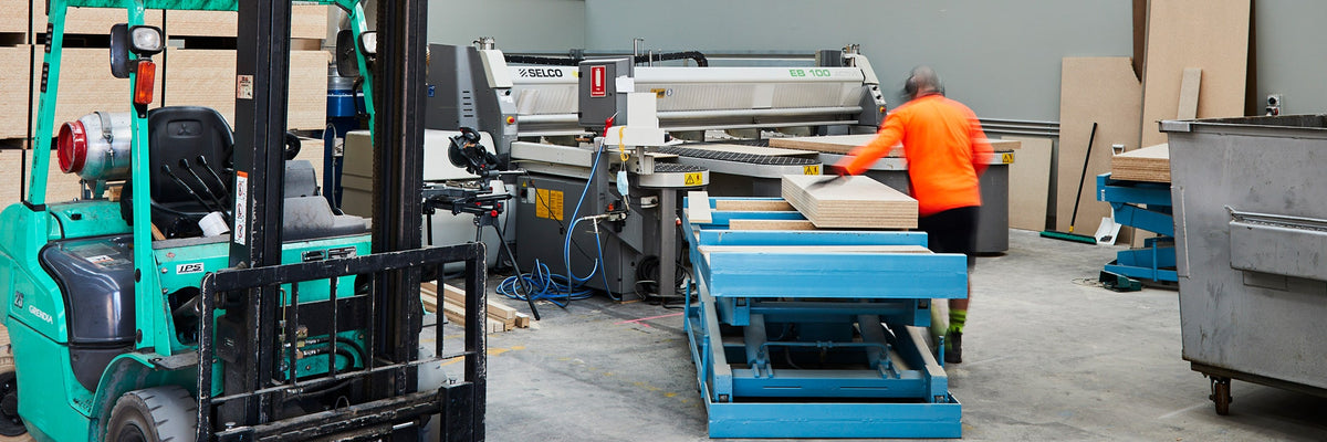 Particle board panels being loaded into an industrial beam saw to be cut to size at Plyco Mornington