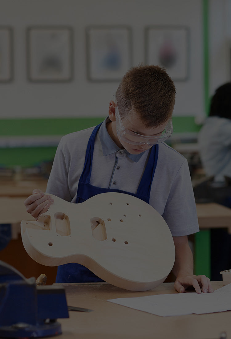 Student crafts a handmade guitar with Plyco's Poplar Laserply panels available to purchase online for educational providers